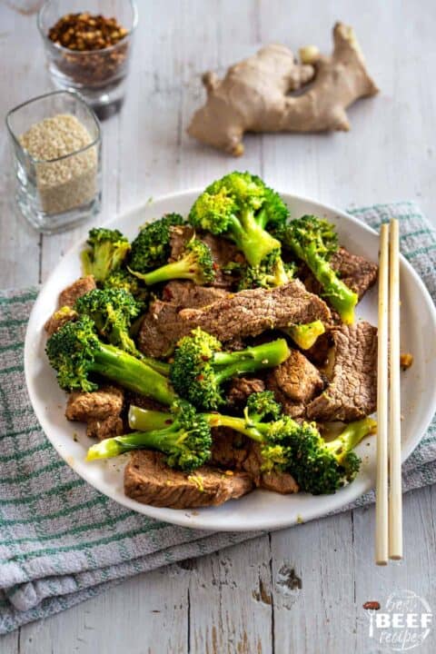 Keto beef and broccoli on a plate with chopsticks
