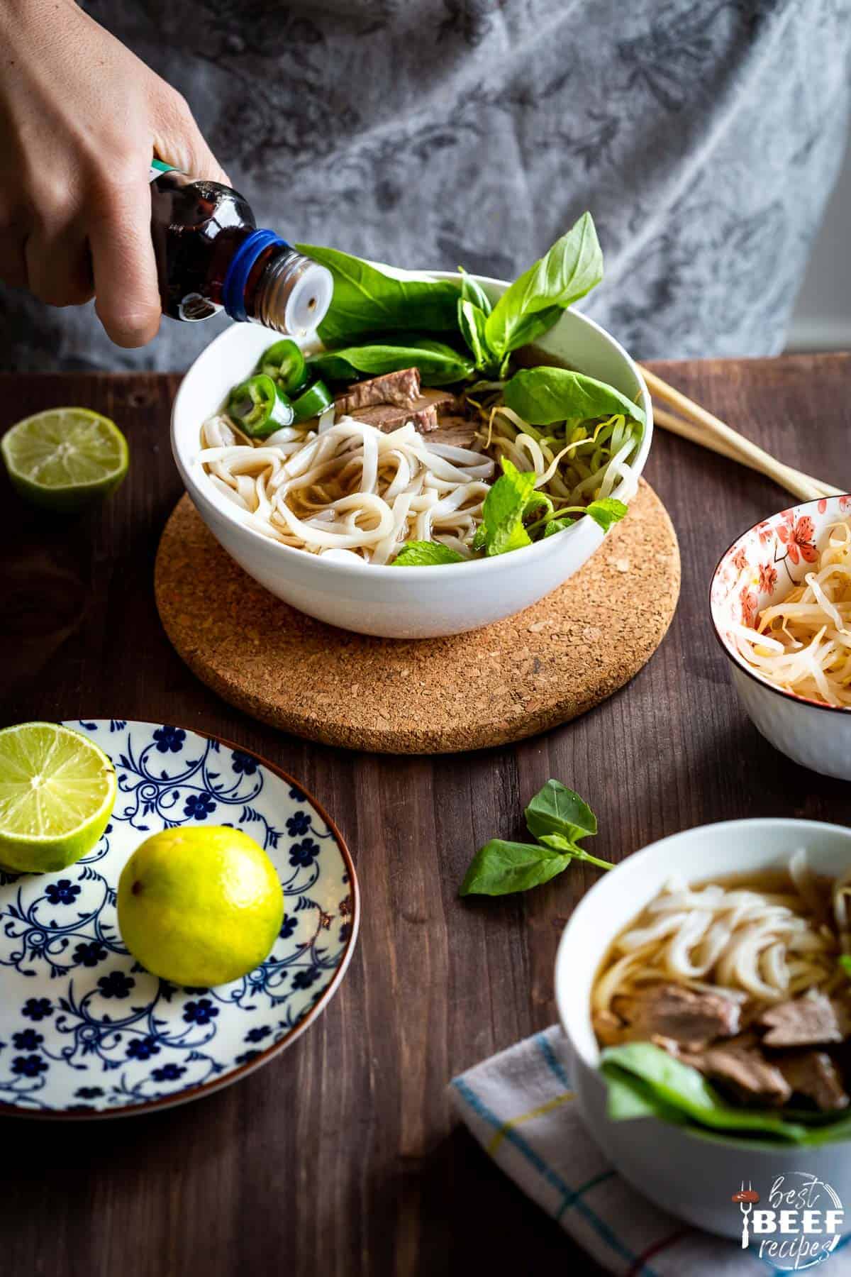 Adding sauce to bowl of instant pot beef pho