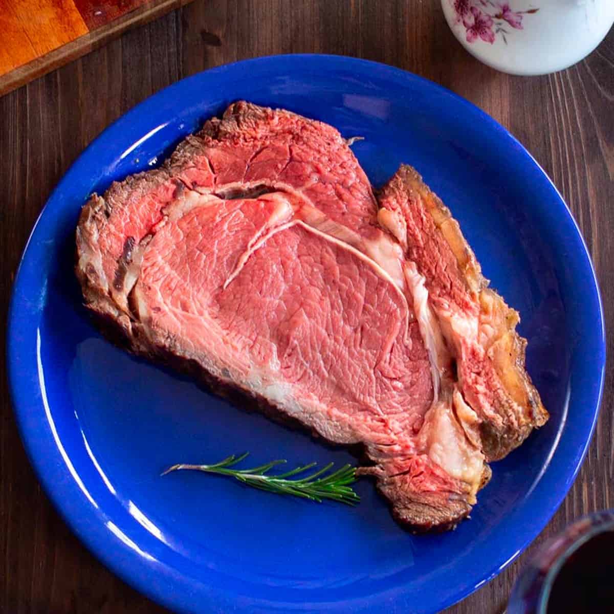 Slice of instant pot prime rib on a blue plate