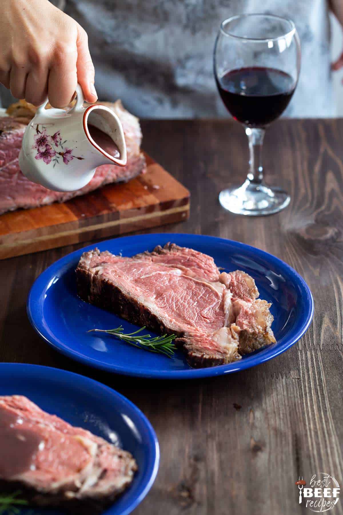 Pouring gravy over slices of prime rib