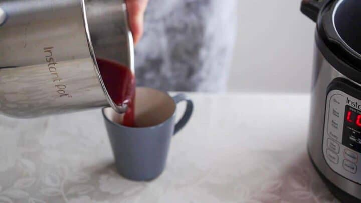Pouring gravy from drippings into a cup