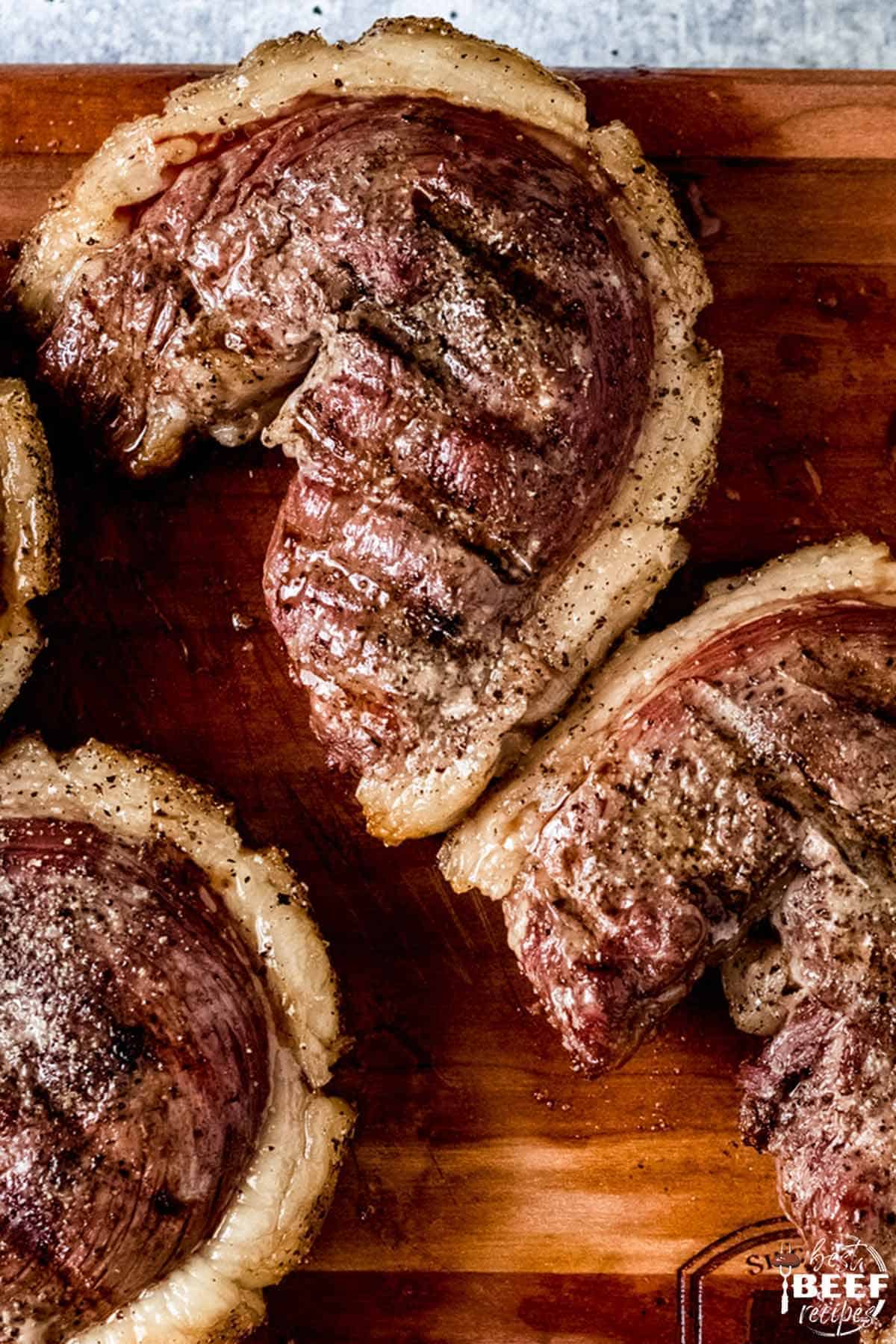 Three cuts of picanha steak on a cutting board