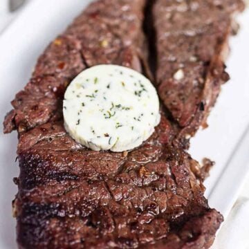 grilled chuck steak with a pat of compound butter on top