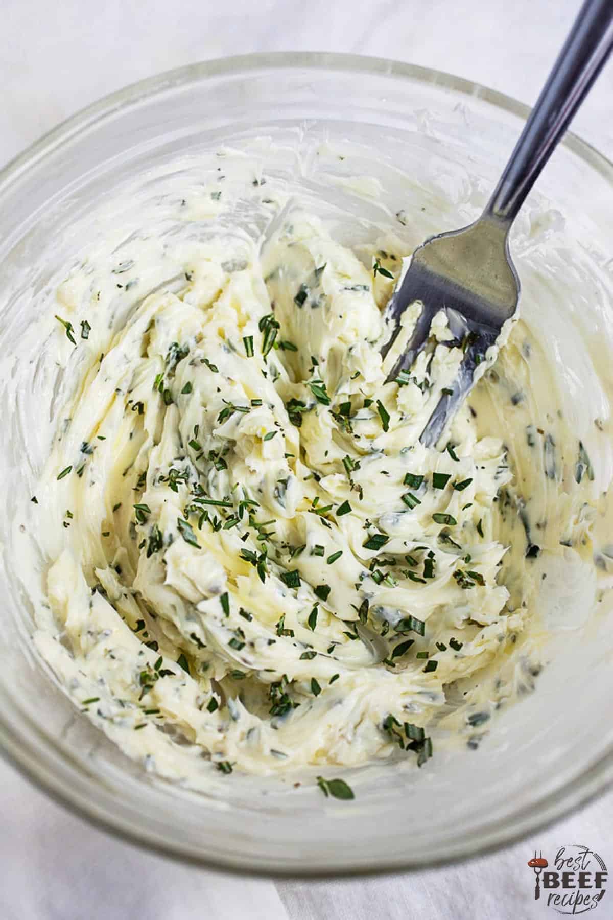 Mixing compound butter in a glass bowl