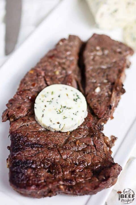 Grilled chuck steak recipe after taking it off the grill with a pat of butter on top