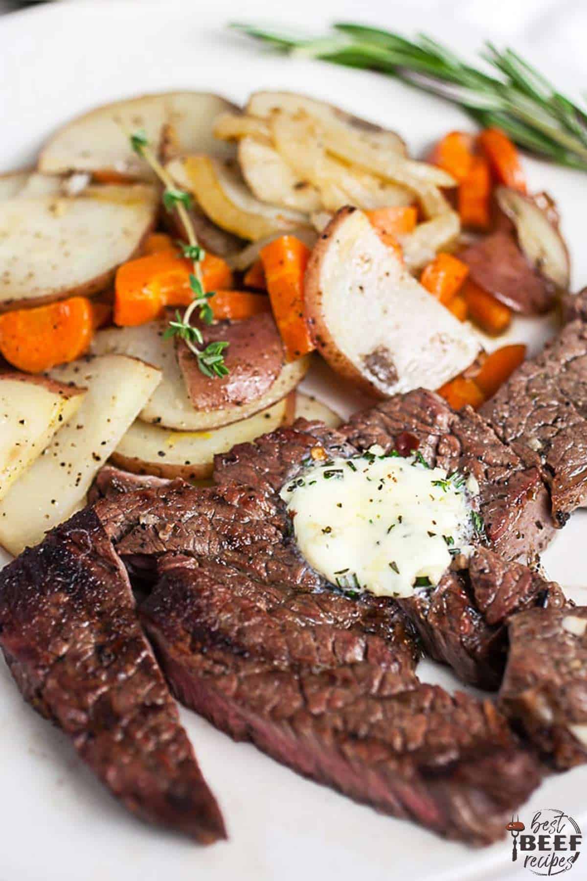 Grilled chuck steak on a white plate with potatoes