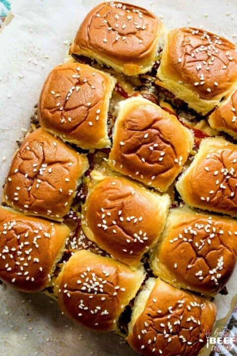 12 bacon cheeseburger sliders on Hawaiian rolls topped with sesame seeds