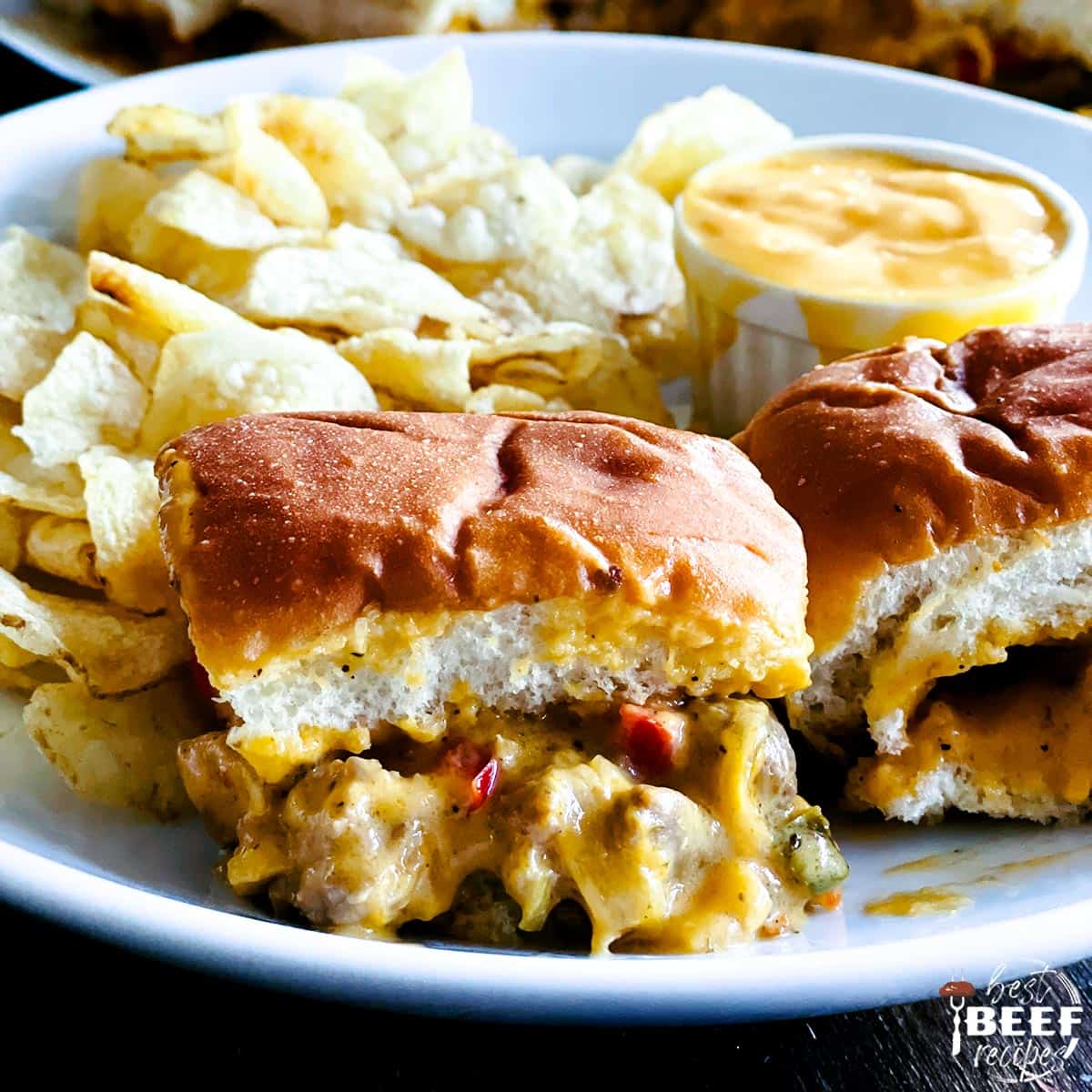 philly cheesesteak sliders on a plate with cheese dip