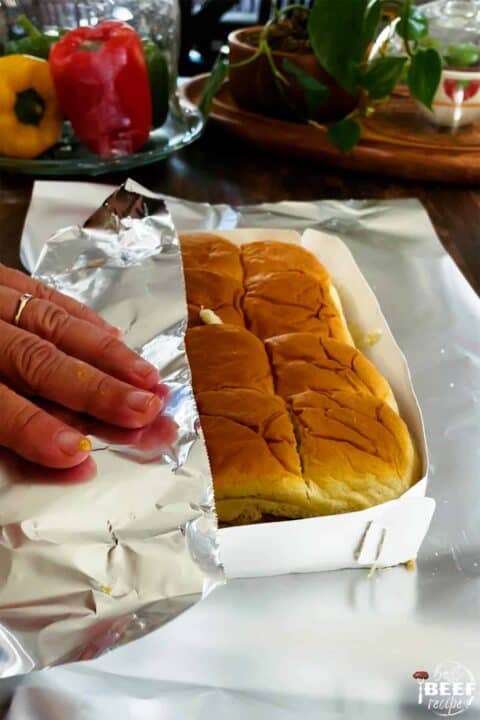 wrapping Hawaiian rolls with tin foil before baking