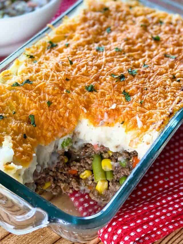 Close up of Instant Pot Shepherd's Pie in a glass casserole dish with a portion missing