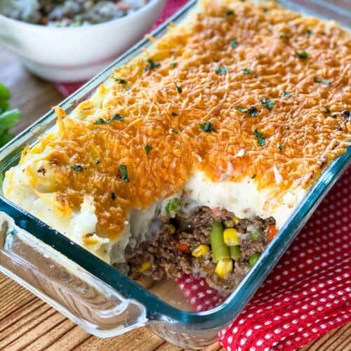 Close up of Instant Pot Shepherd's Pie in a glass casserole dish with a portion missing