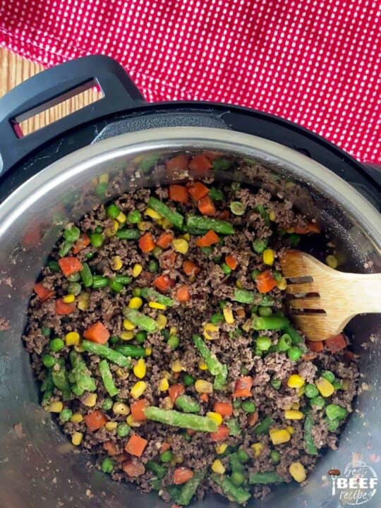 Mixed vegetables and ground beef cooking in the instant pot