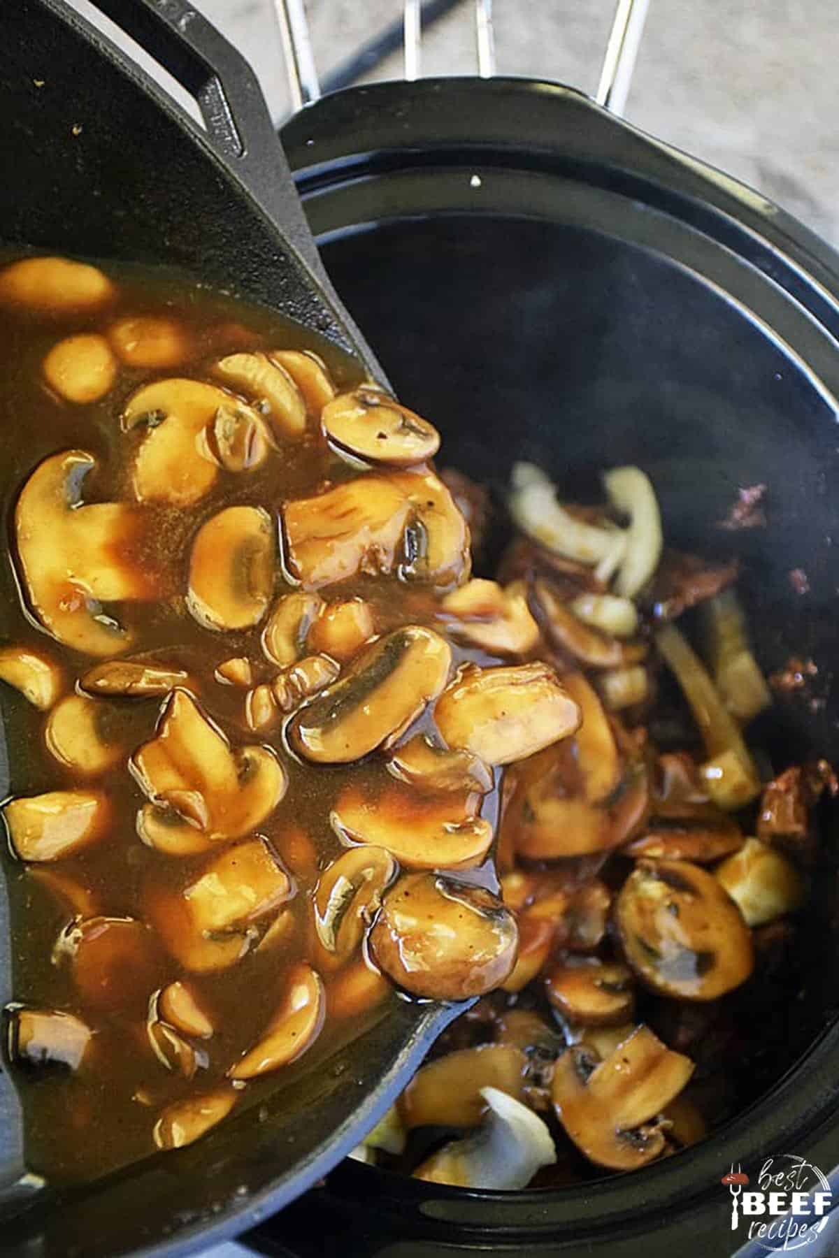 Pouring the mushroom gravy into the slow cooker with the beef tips