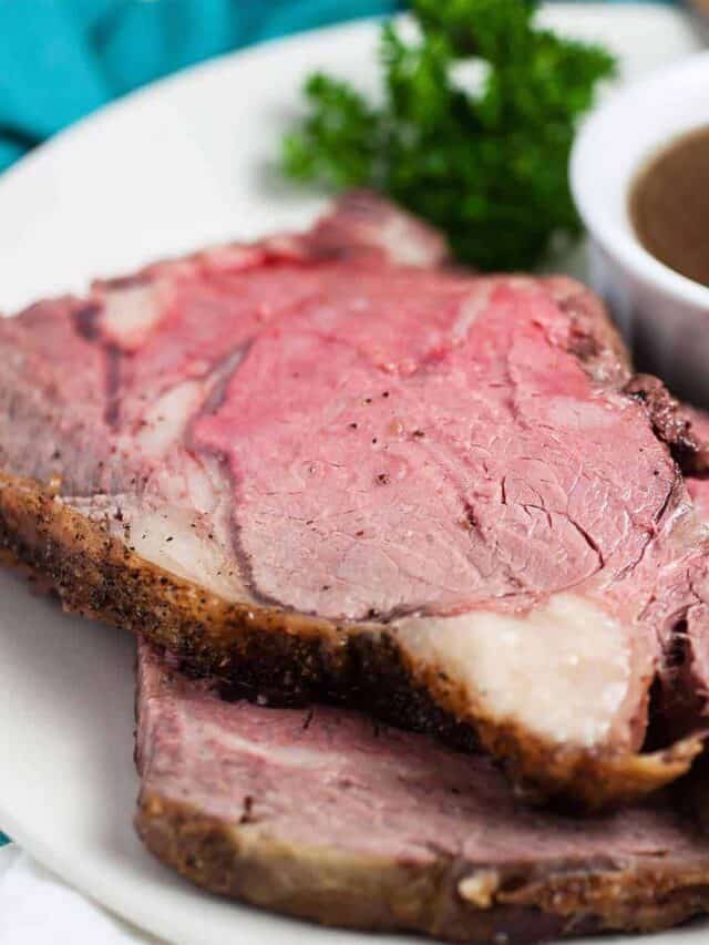 Two slices of boneless prime rib roast on a white plate