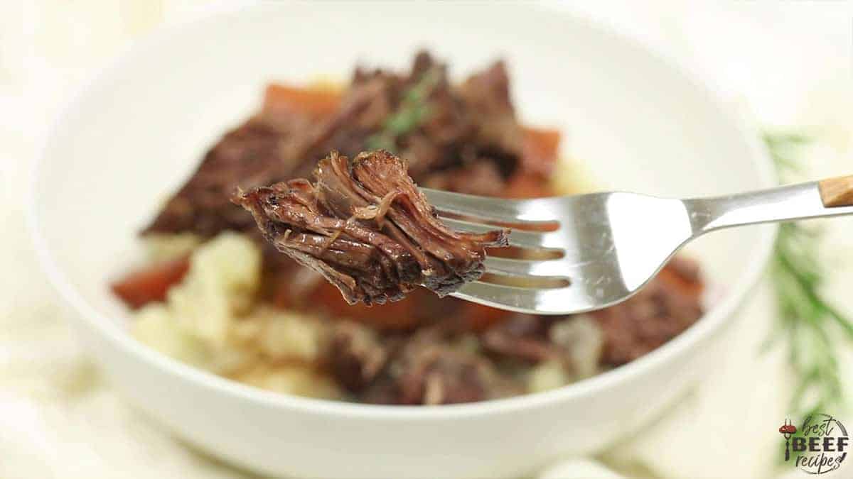 A fork with a bite of Dutch Oven Pot Roast