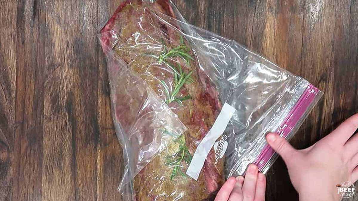 Sealing the plastic bag with the tenderloin in it