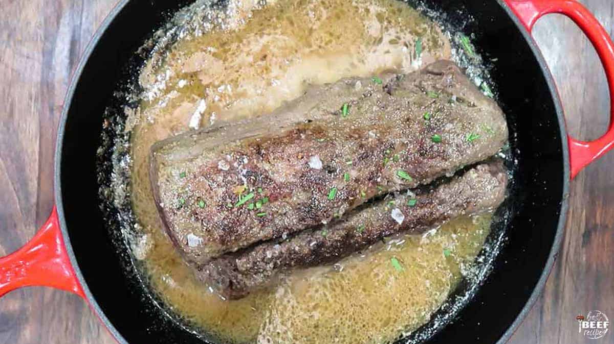 Searing beef tenderloin in the skillet with butter