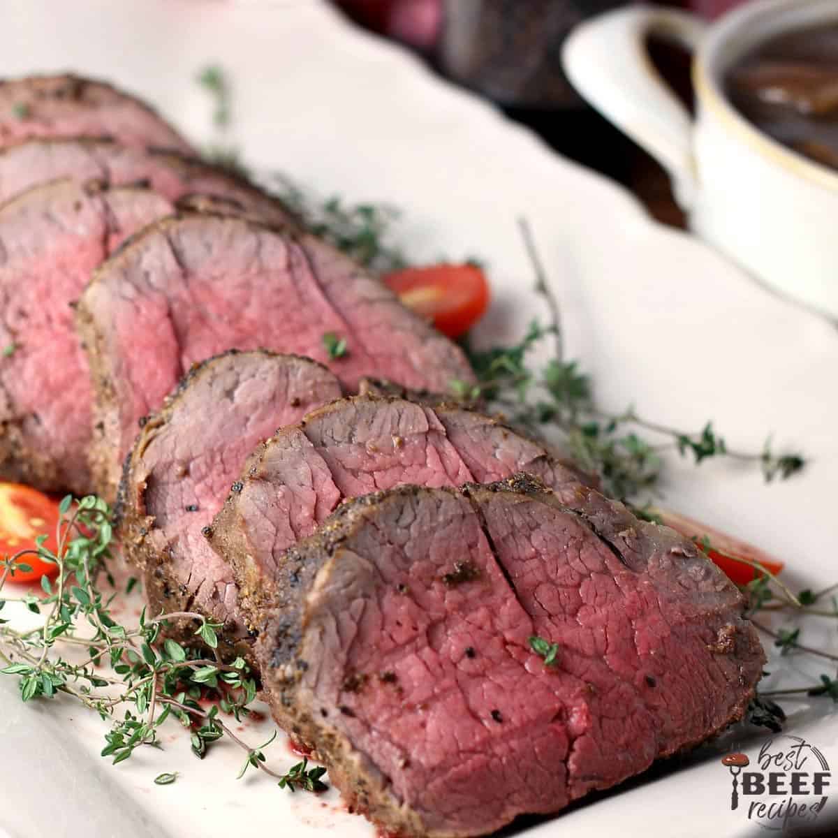 Slices of whole beef tenderloin on a white platter