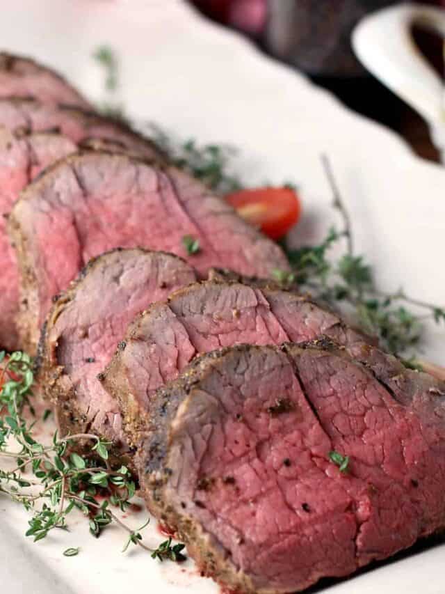 Slices of whole beef tenderloin on a white platter