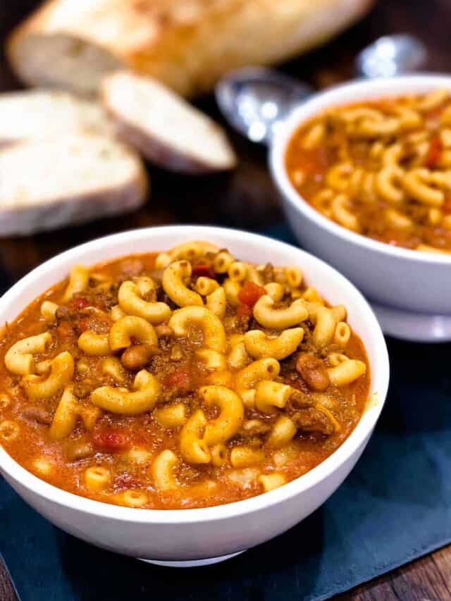 Two white bowls of instant pot chili mac with french bread slices