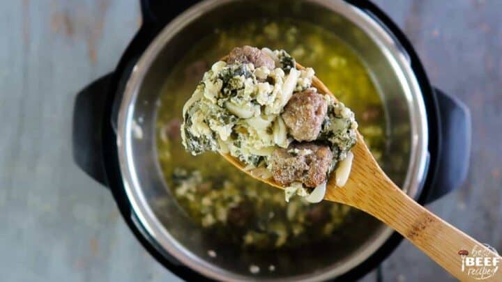 Showing the meatballs from the Italian wedding soup on a wooden spoon