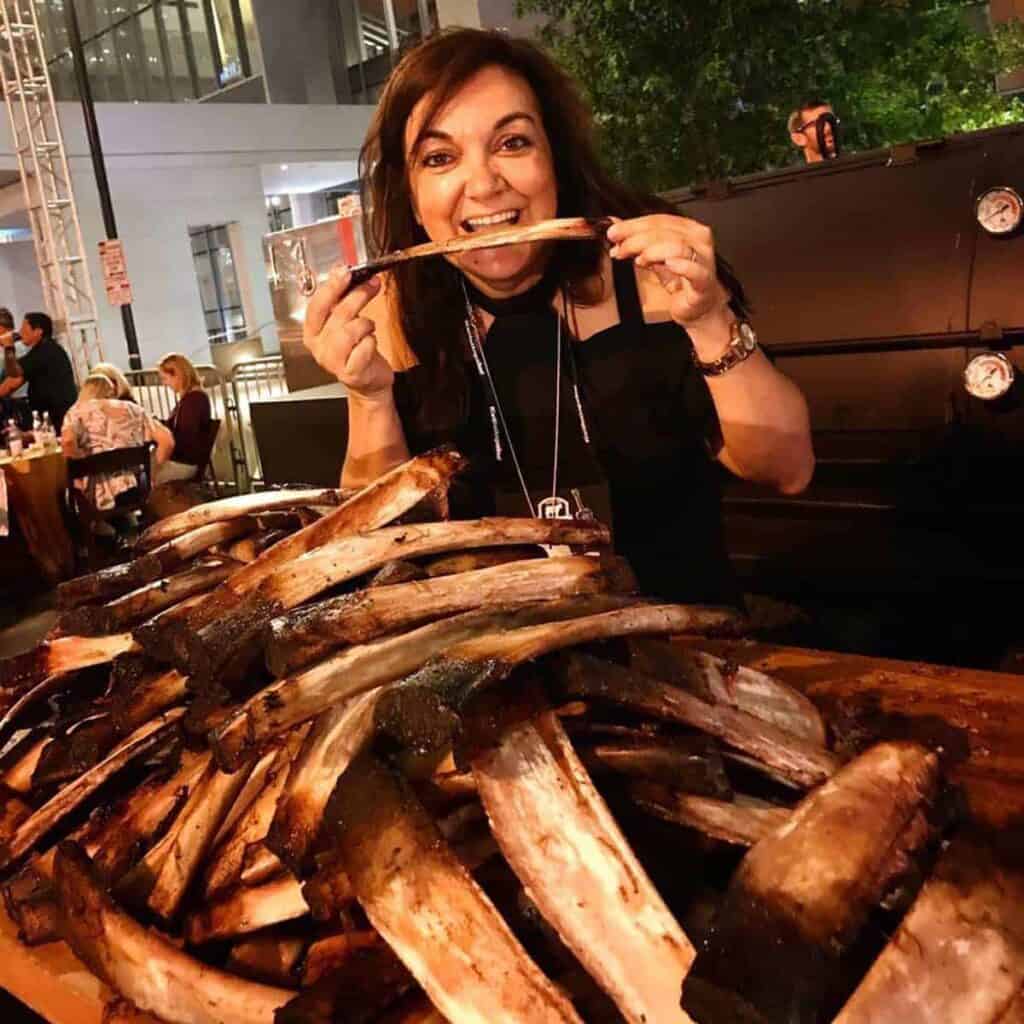 Isabel smiling with a stack of ribs