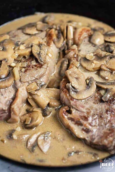 Steak with mushroom sauce in the skillet
