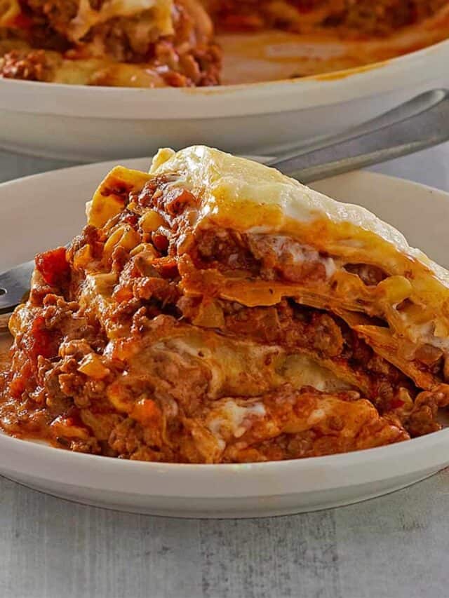 instant pot lasagna on a white plate with a fork