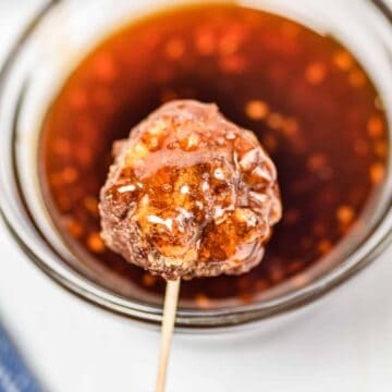 Meatball on a toothpick with honey sriracha sauce