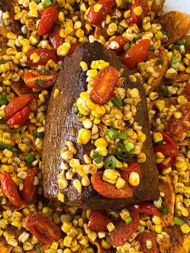 Eye round roast on a bed of sweet potatoes with corn and tomatoes