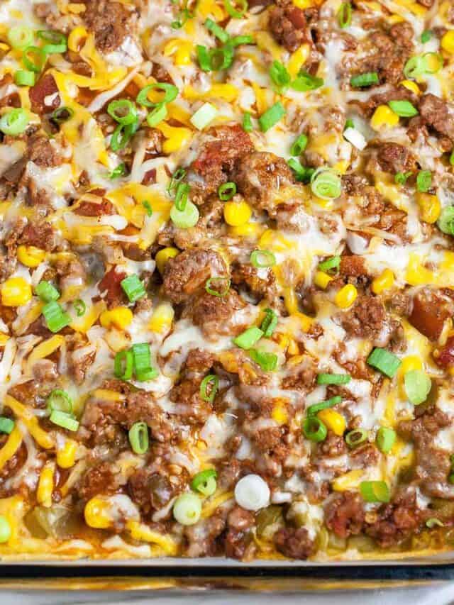 Close up Mexican ground beef casserole in glass dish