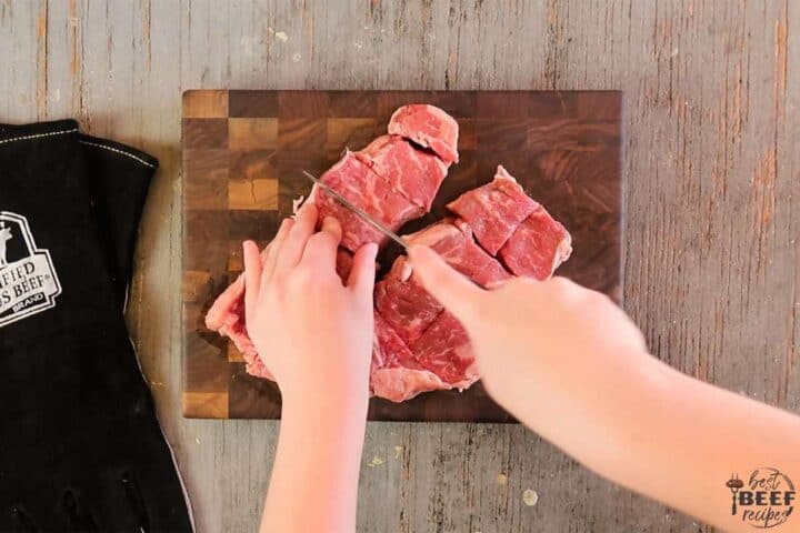 Cutting strip steaks into cubes