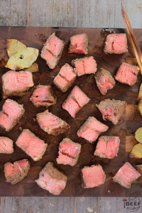 Chunks of cooked beef kabobs on a cutting board