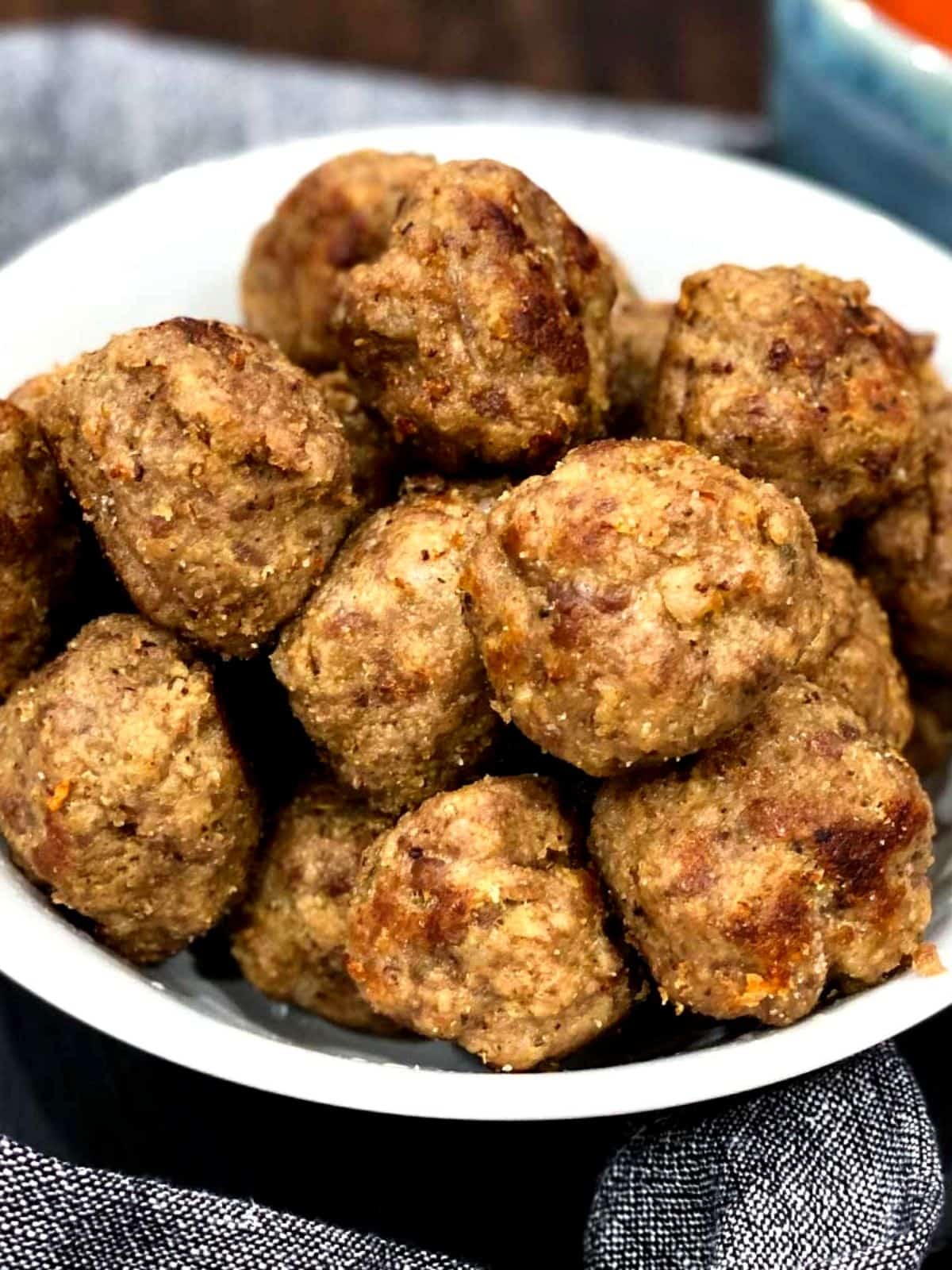 meatballs stacked on a white dish