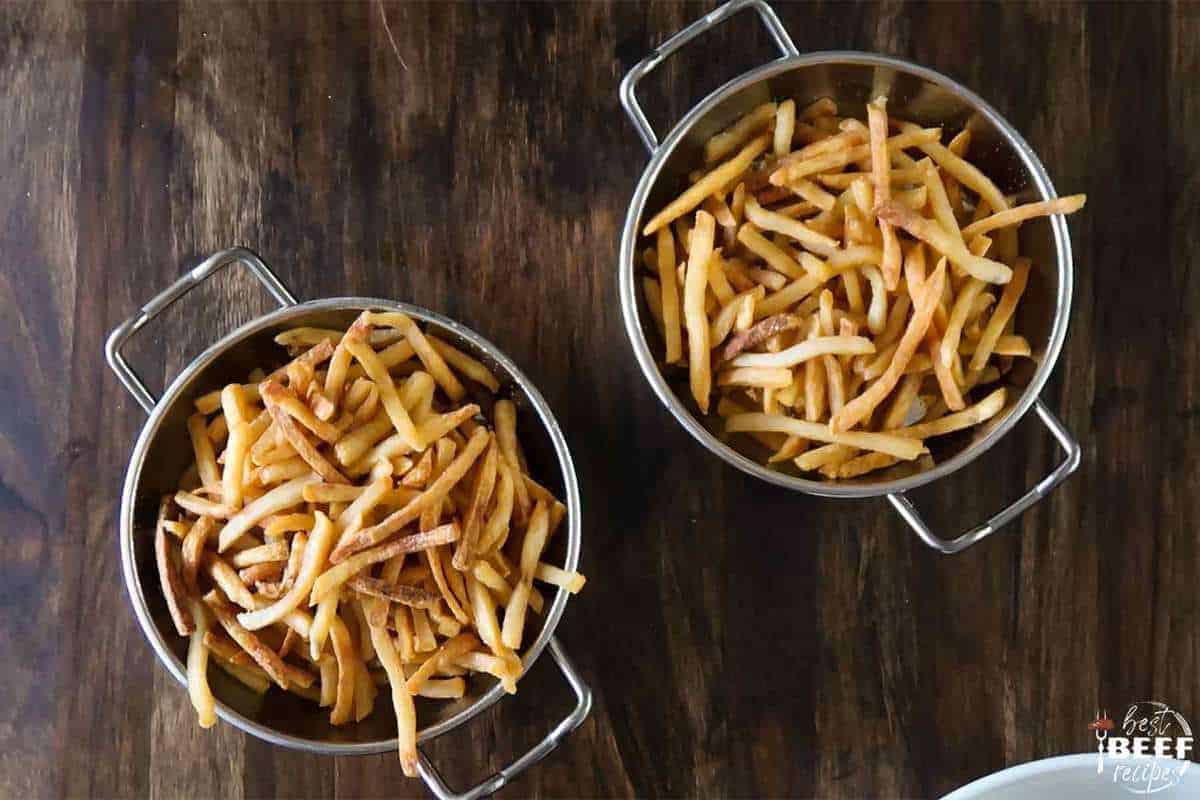 French fries in two metal baking dishes
