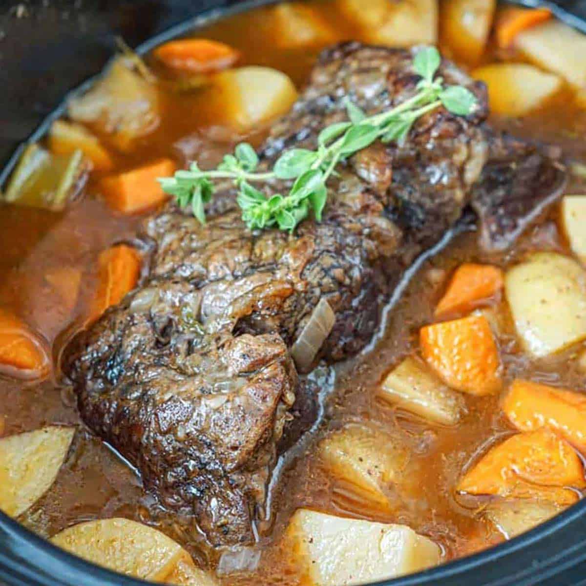 Slow cooker chuck roast in the crockpot with potatoes and carrots