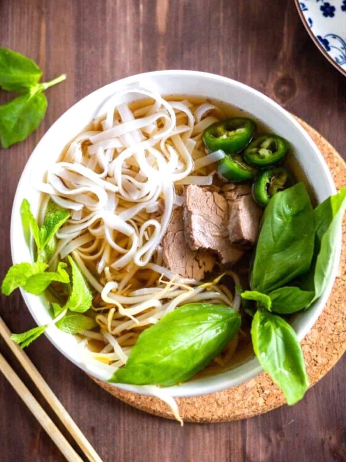 Instant Pot Beef Pho in a white bowl.