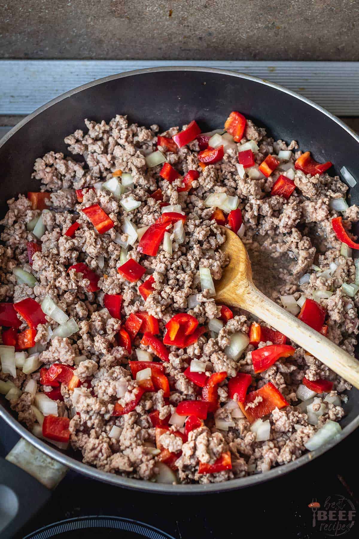 Ground beef with peppers and onions in the skillet