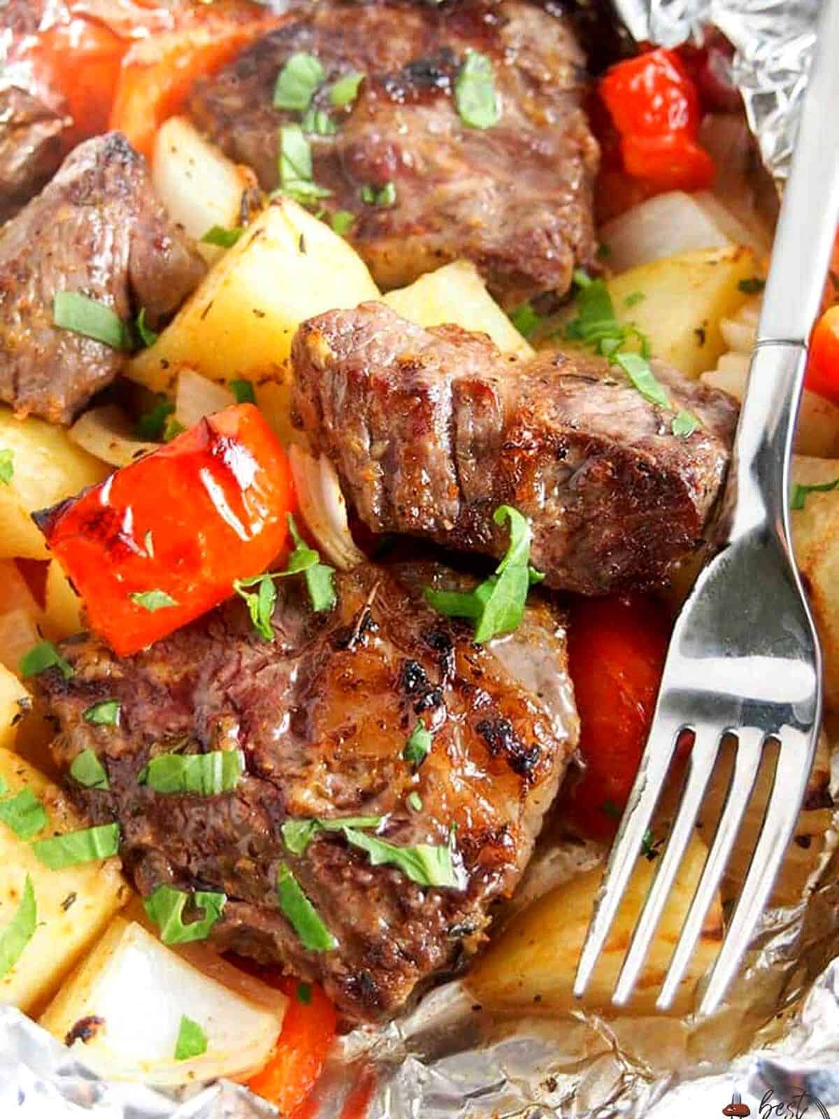 Steak with potatoes and pepper in foil.