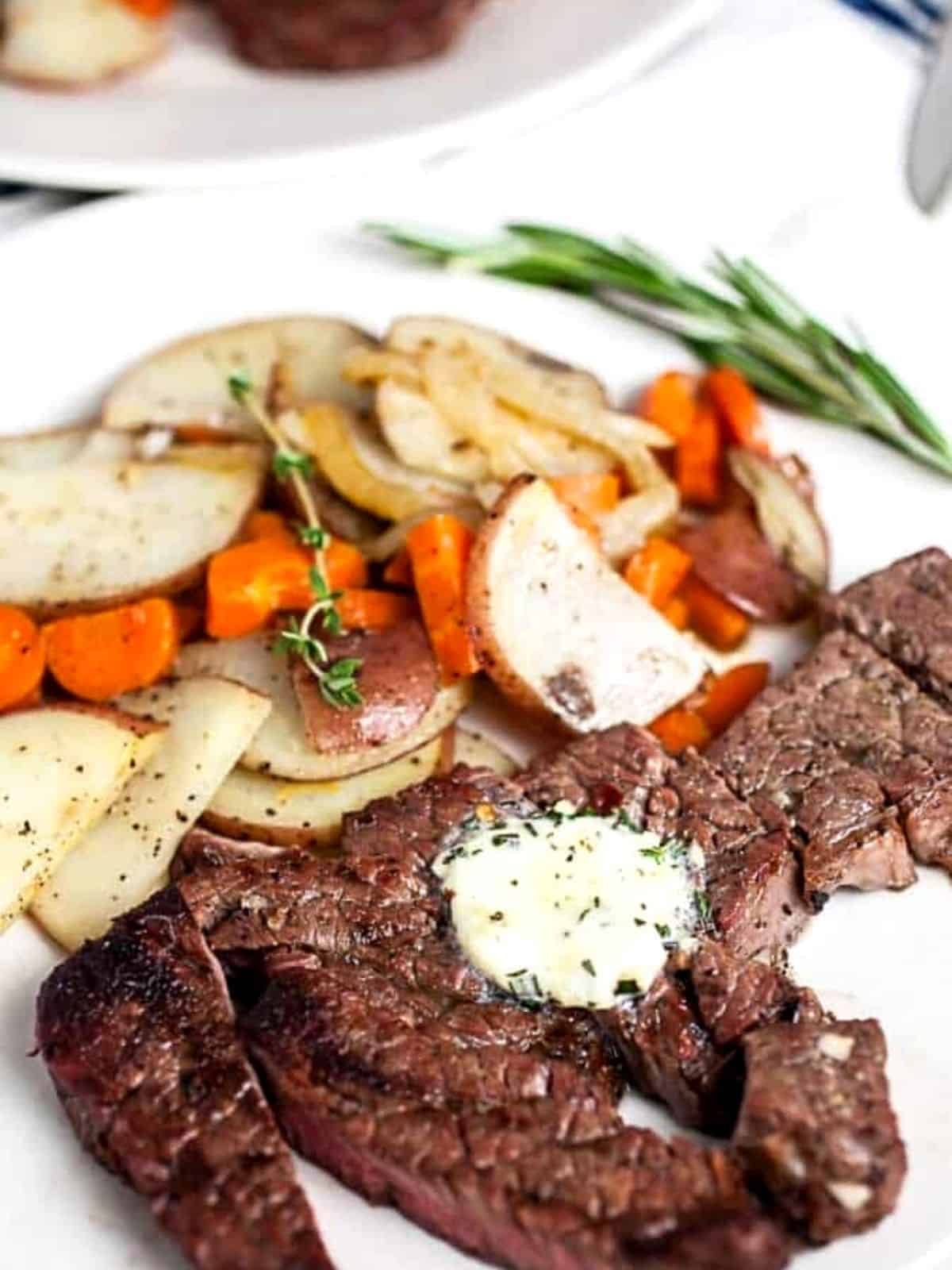 Steak with compound butter and vegetables.
