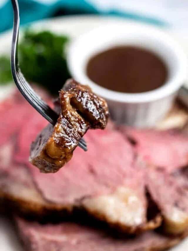 Boneless prime rib being picked up by a fork.