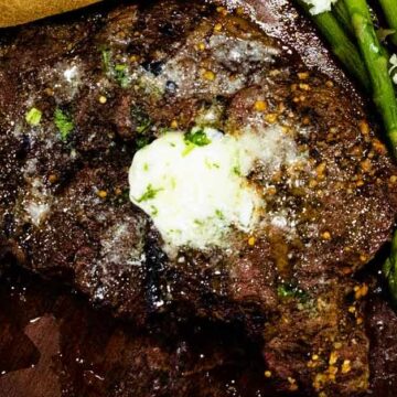 Overhead photo of rib eye steak with garlic butter for steak