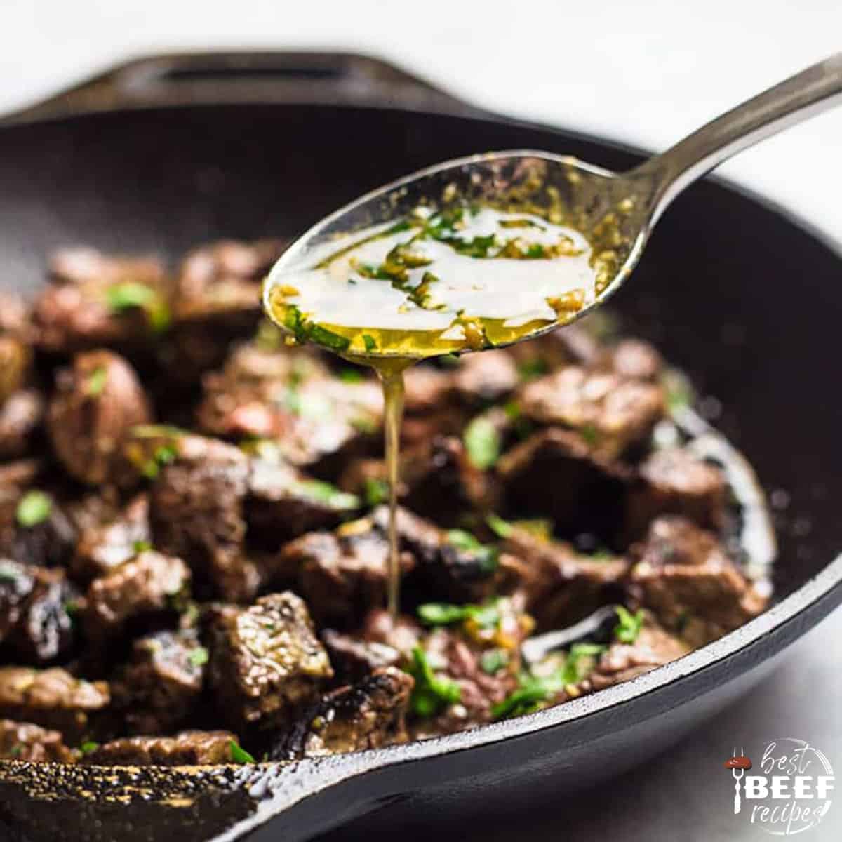 Pouring garlic butter over steak bites