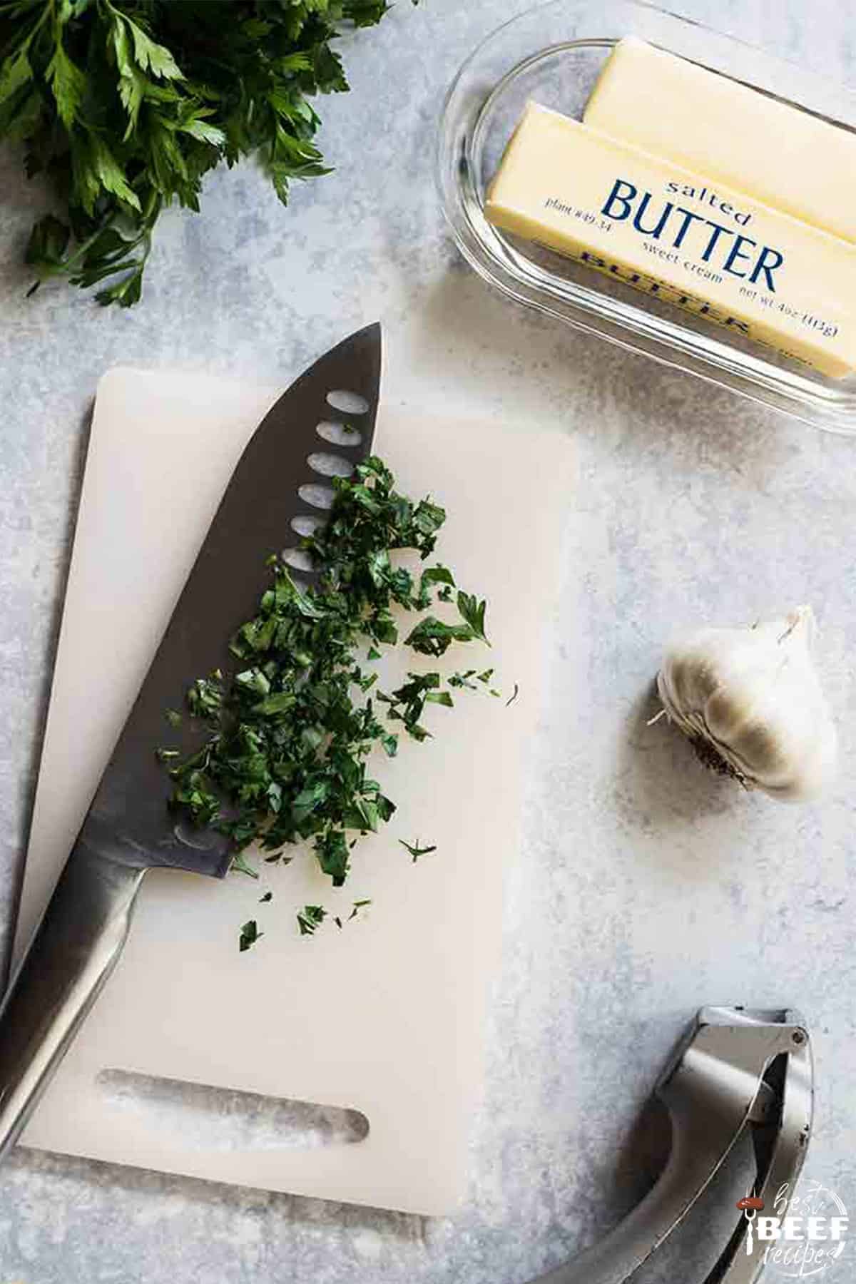 Chopping fresh herbs to make garlic butter