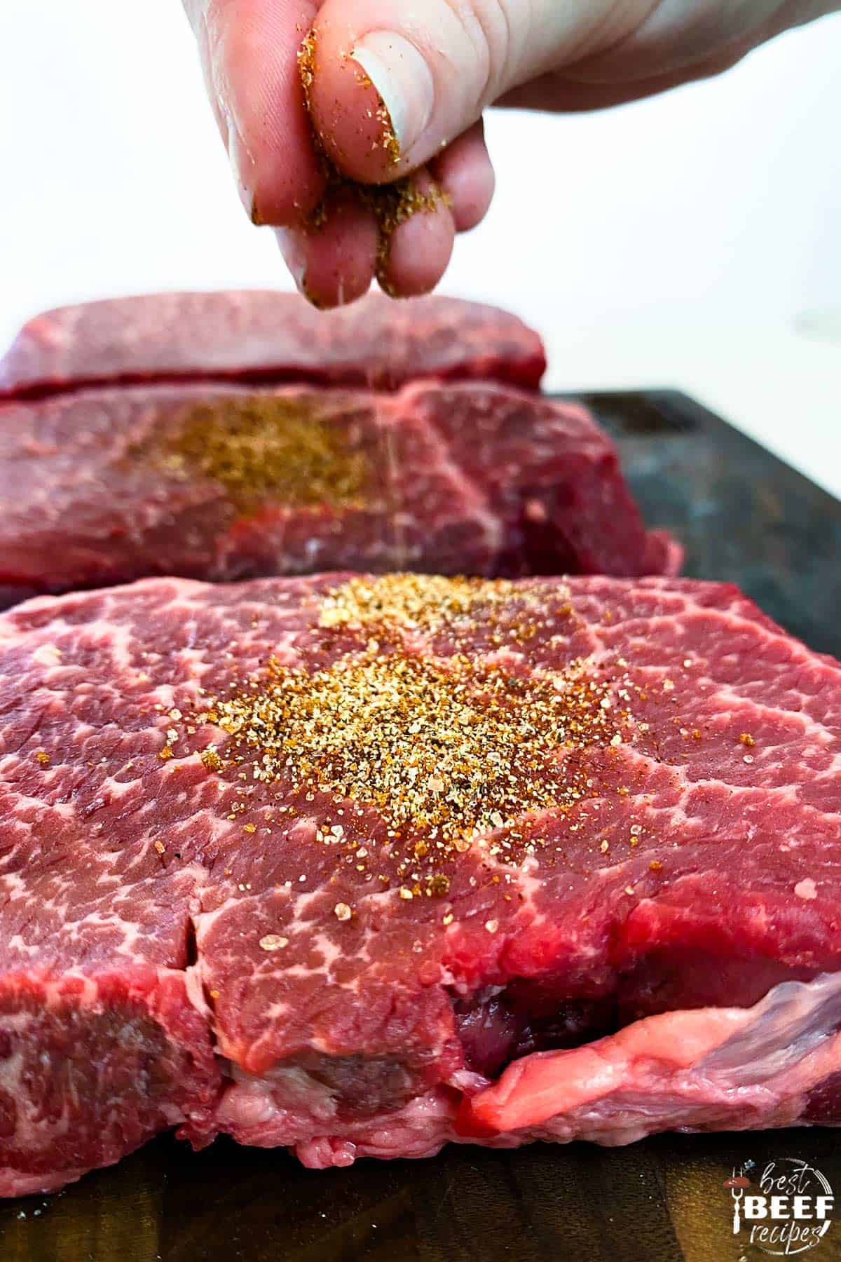 Sprinkling seasoning on steak