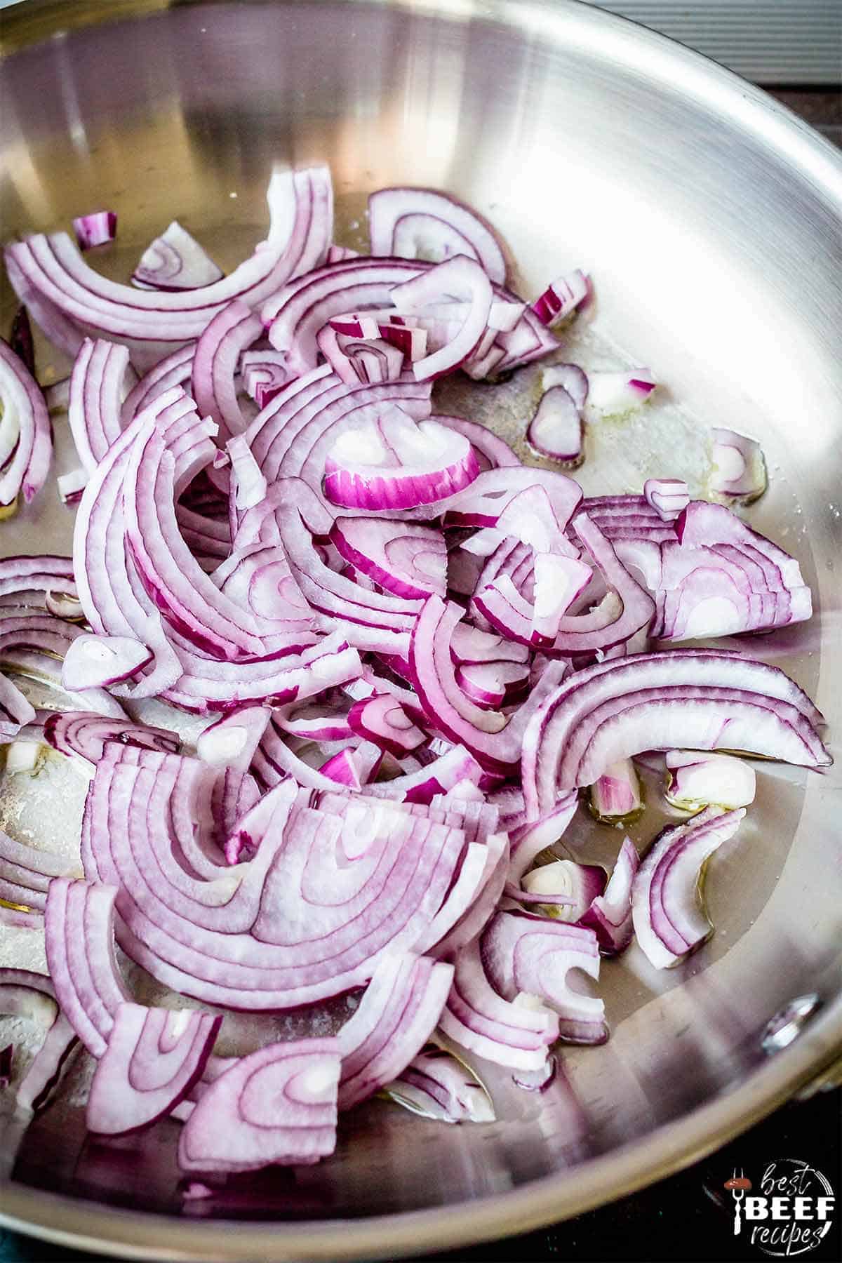 Sliced red onions in a pan