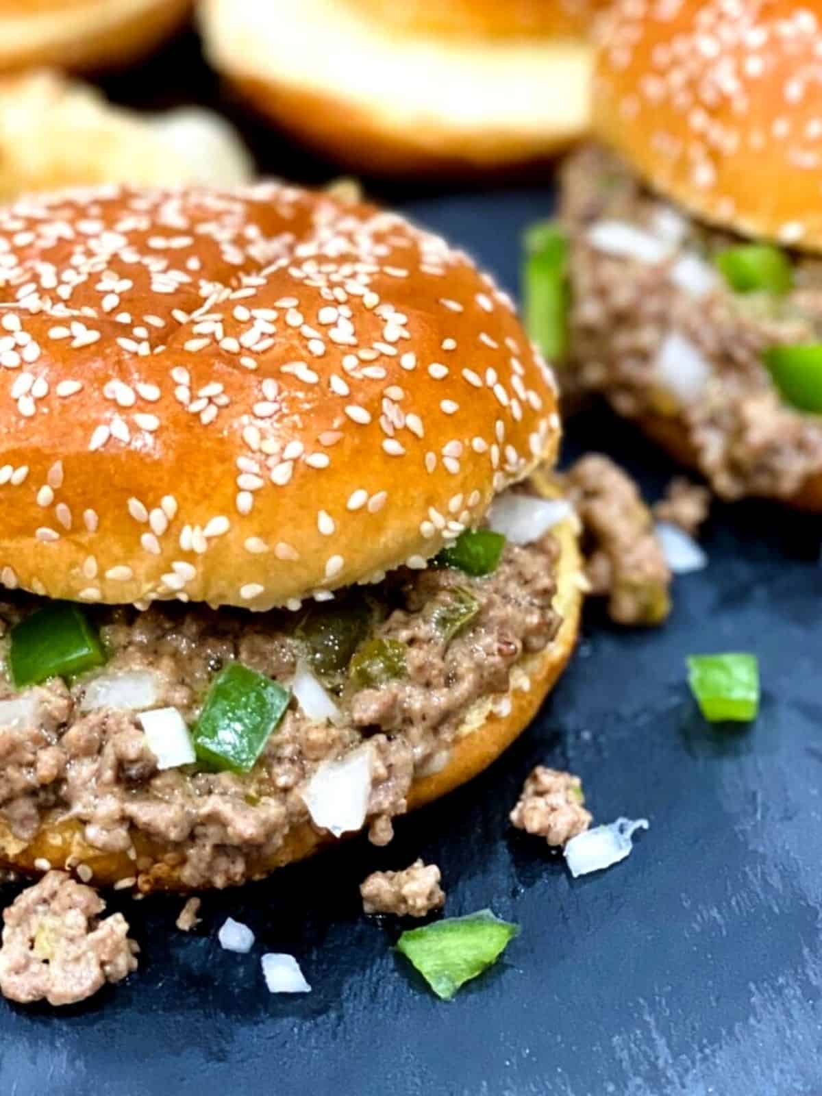 Sloppy Joes served on a burger bun with green pepper and onion.