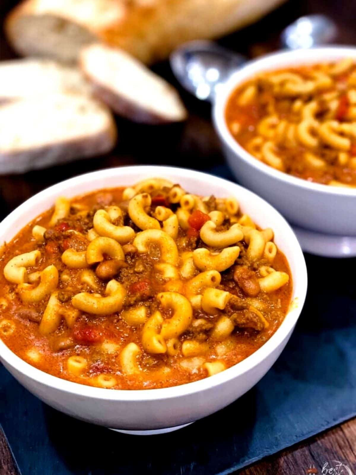 Chili mac and cheese in a white bowl.