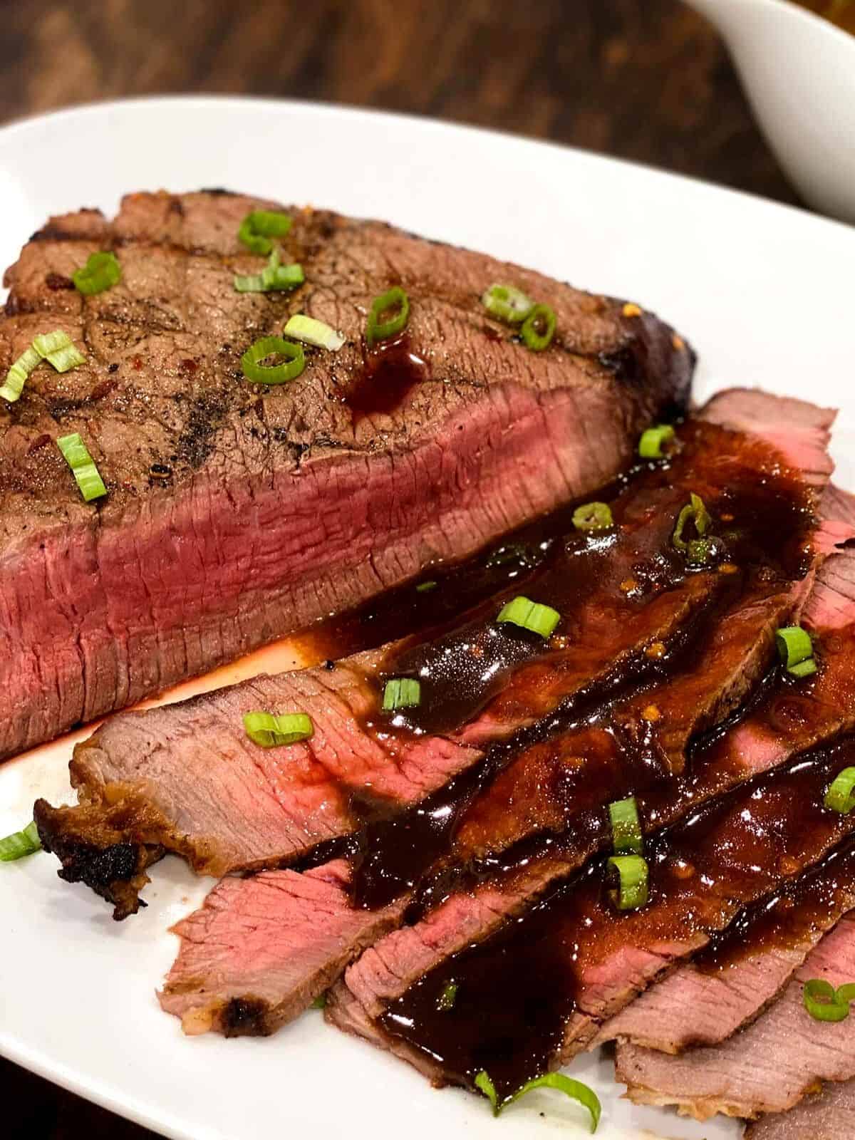 London broil sliced topped with marinade.