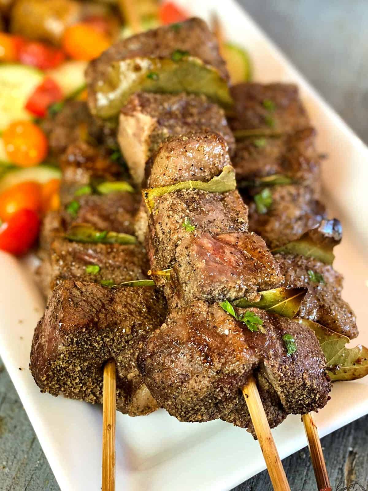 Beef kabobs with bay leaves in between.
